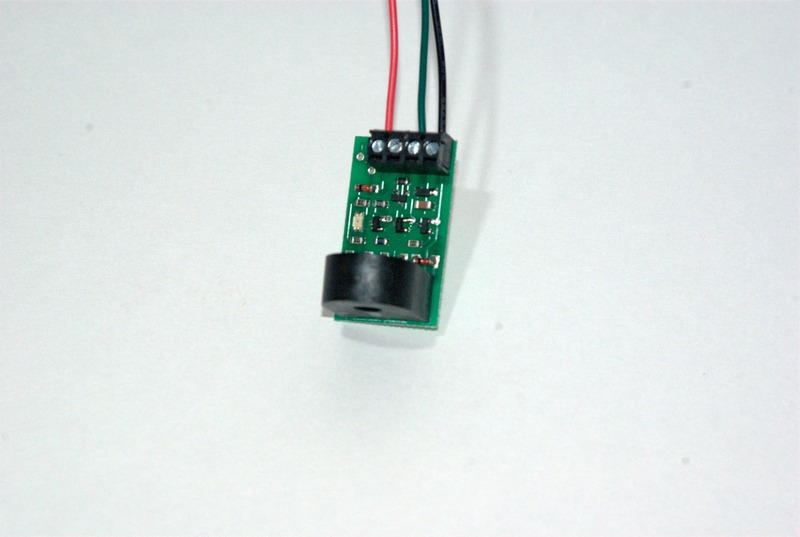 An NCE BD20.  The red wire connects to +5VDC on the Arduino.  The black wire is connected to a ground connection on the Arduino, and the green wire is connected to one of pins 6 or 7.